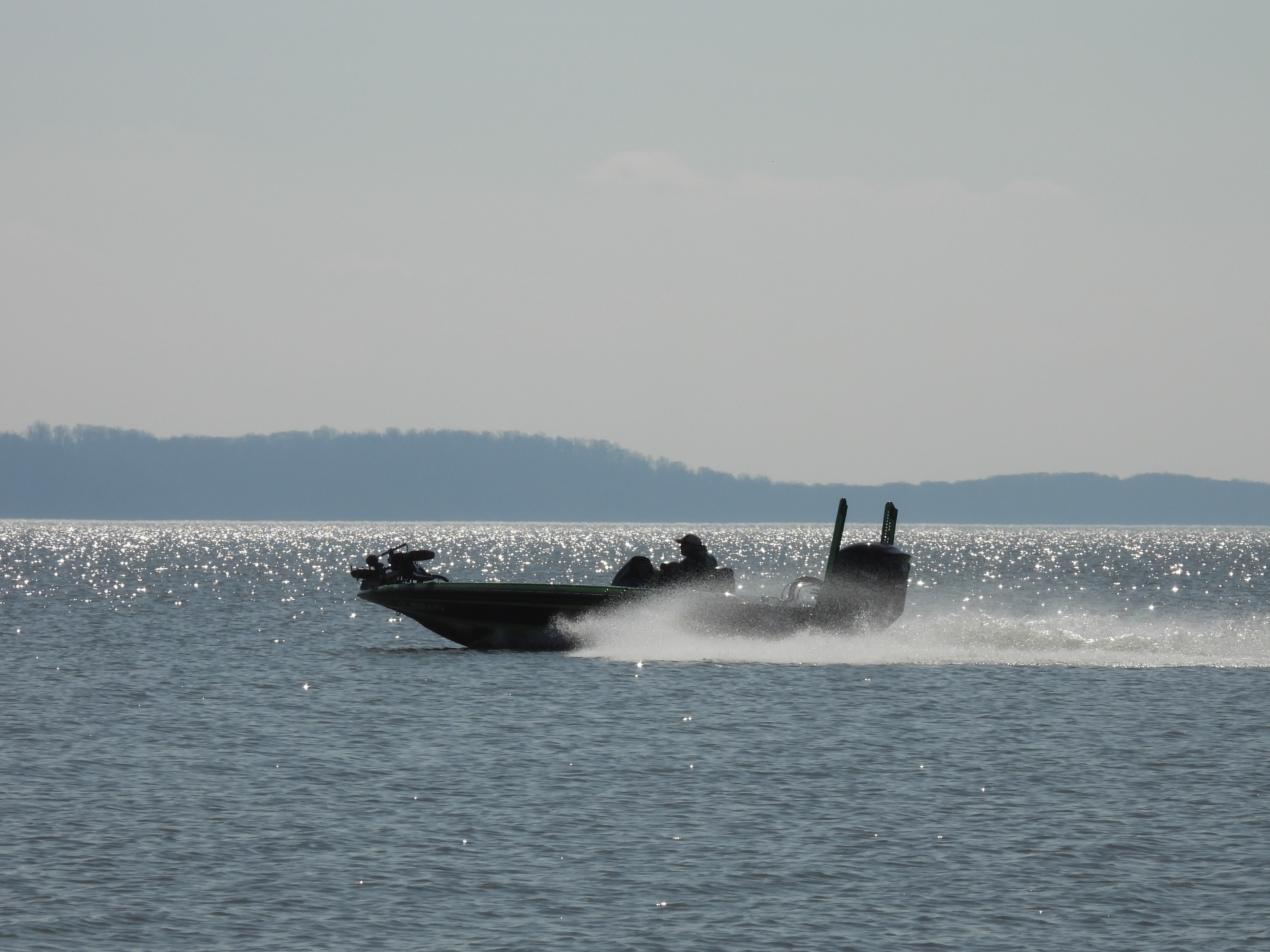 A boat with fishermen drives across on the Susquehanna Flats